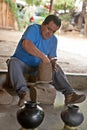 A mexican potter working on a vase in San Bartolo Coyotepec